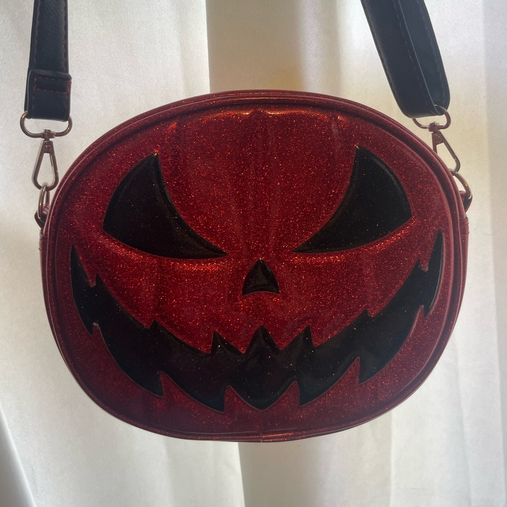 Red and Black Crossbody Bag with Pumpkin Face Design
